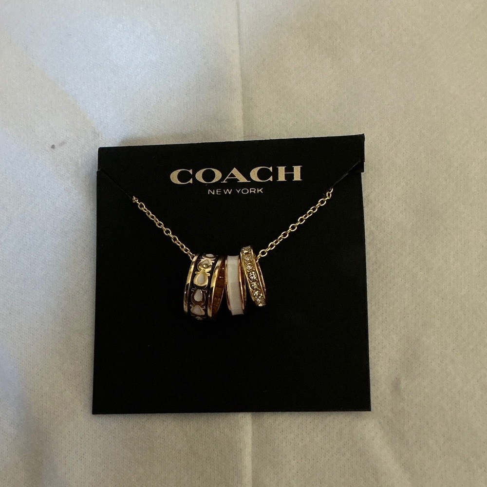 COACH Gold-Tone Multi-Ring Pendant Necklace with White Enamel